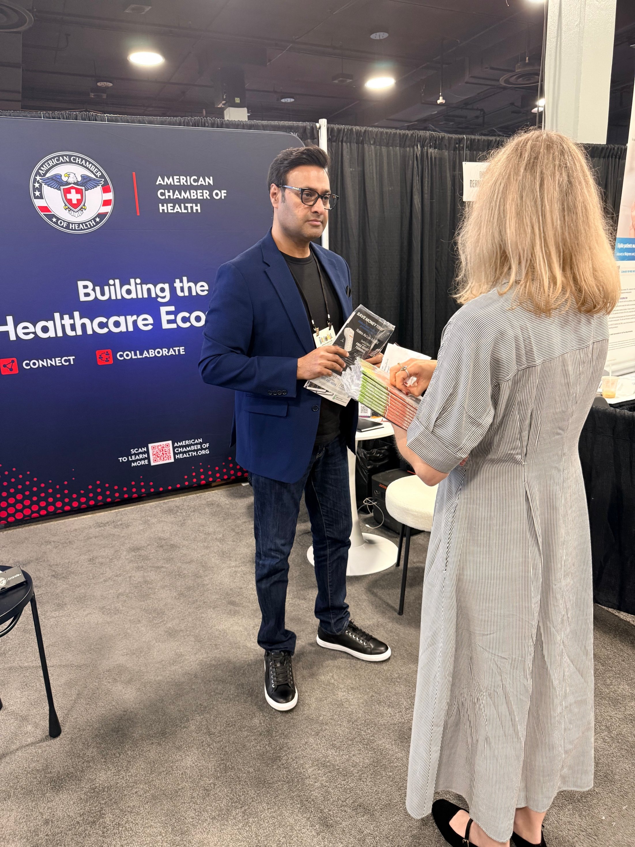 Khalid Sattar speaking with an attendee at the ACH booth in Nashville