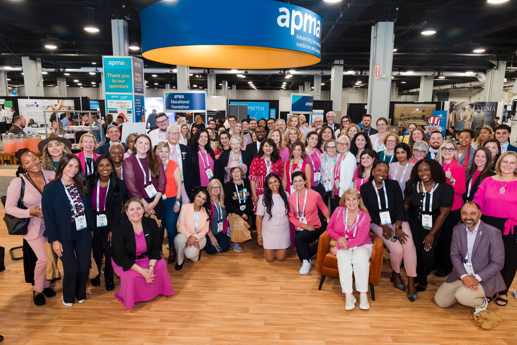Large group of APMA attendees posing beneath the APMA overhead sign at The National in Nashville