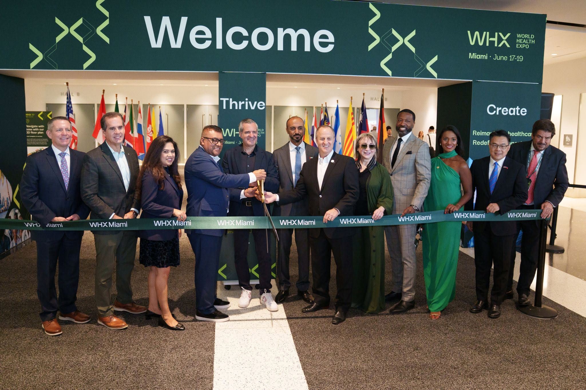 Dignitaries cut the ribbon to open WHX Miami beneath the welcome arch