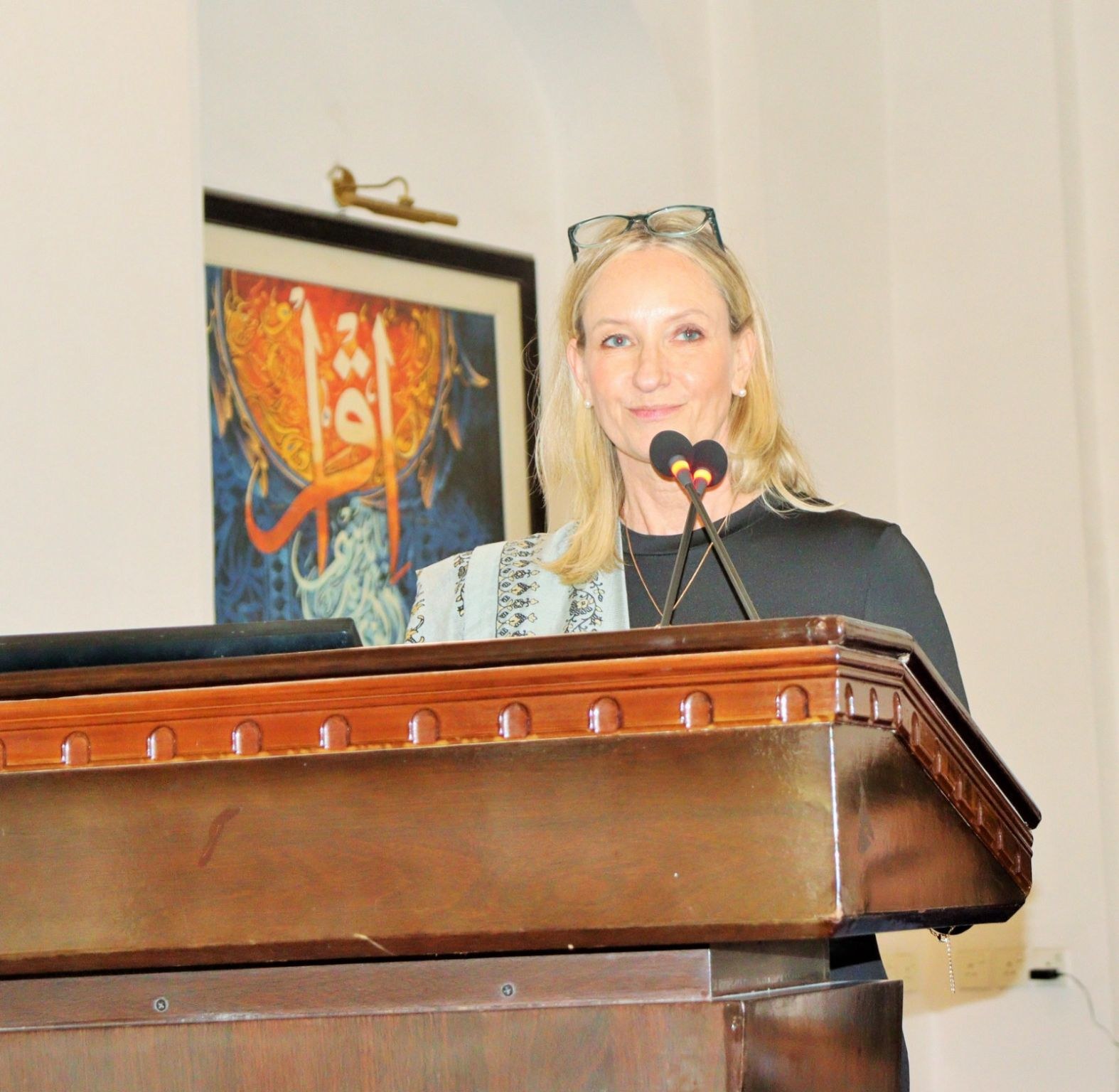 A speaker addresses the audience from the podium in Lahore