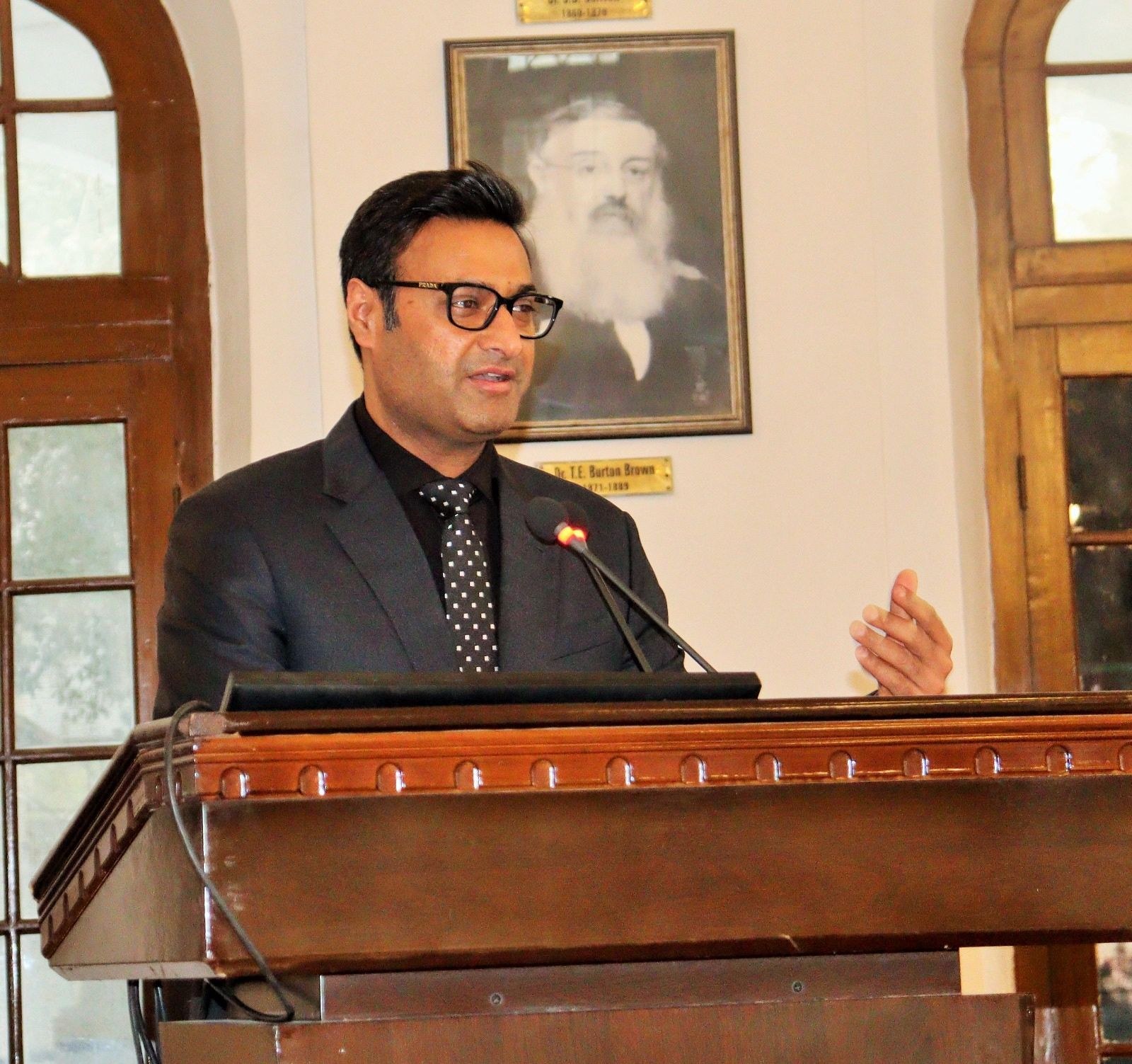 ACH President Khalid Sattar speaks from the podium at KEMU